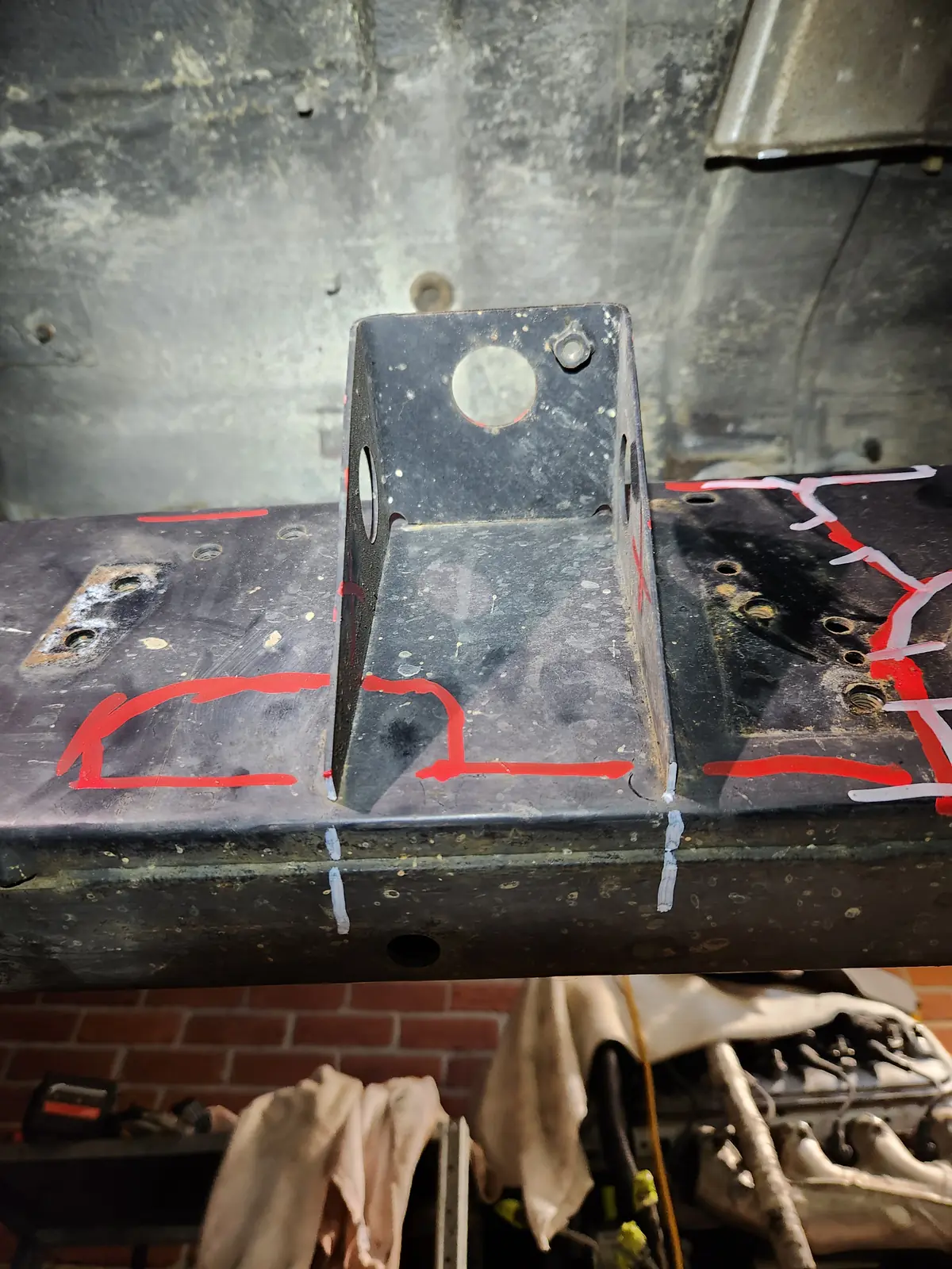 Chassis rail marked in red paint around a bracket, ready for a plate