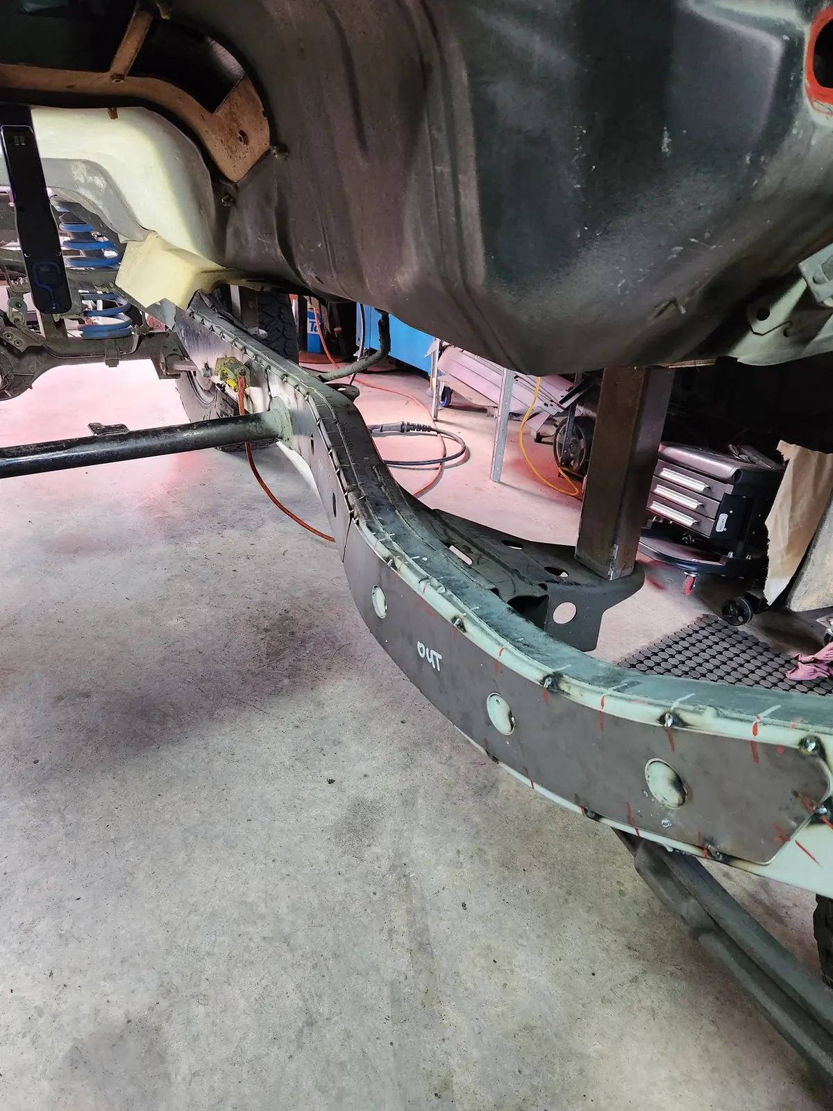 Chassis rail under the body with welded reinforcing plates
