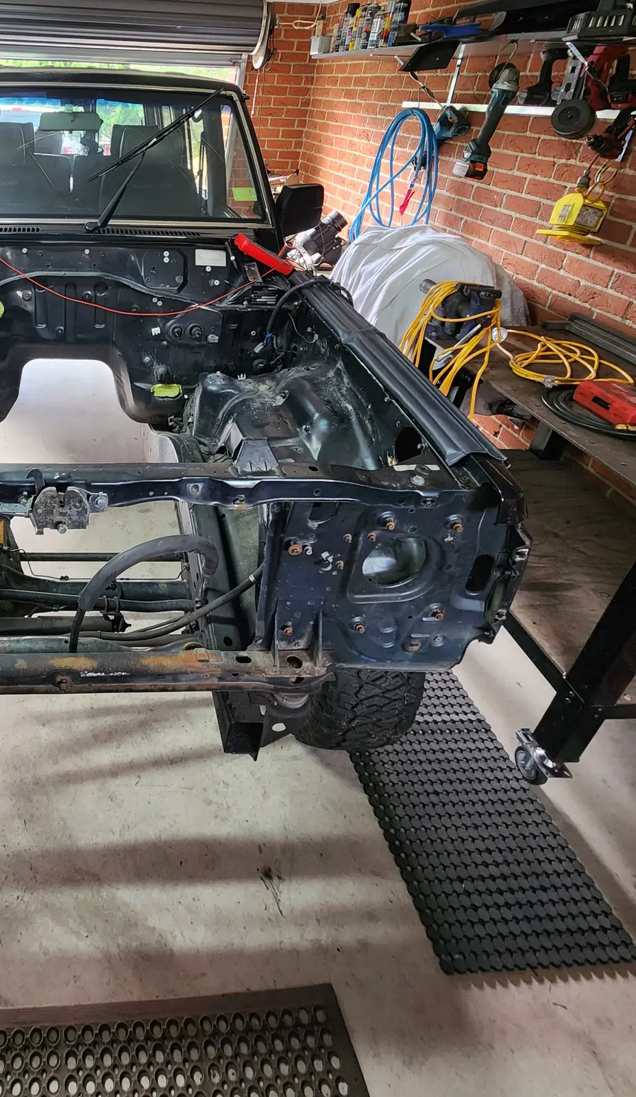 Patrol in a home garage with the engine removed and the front panels off