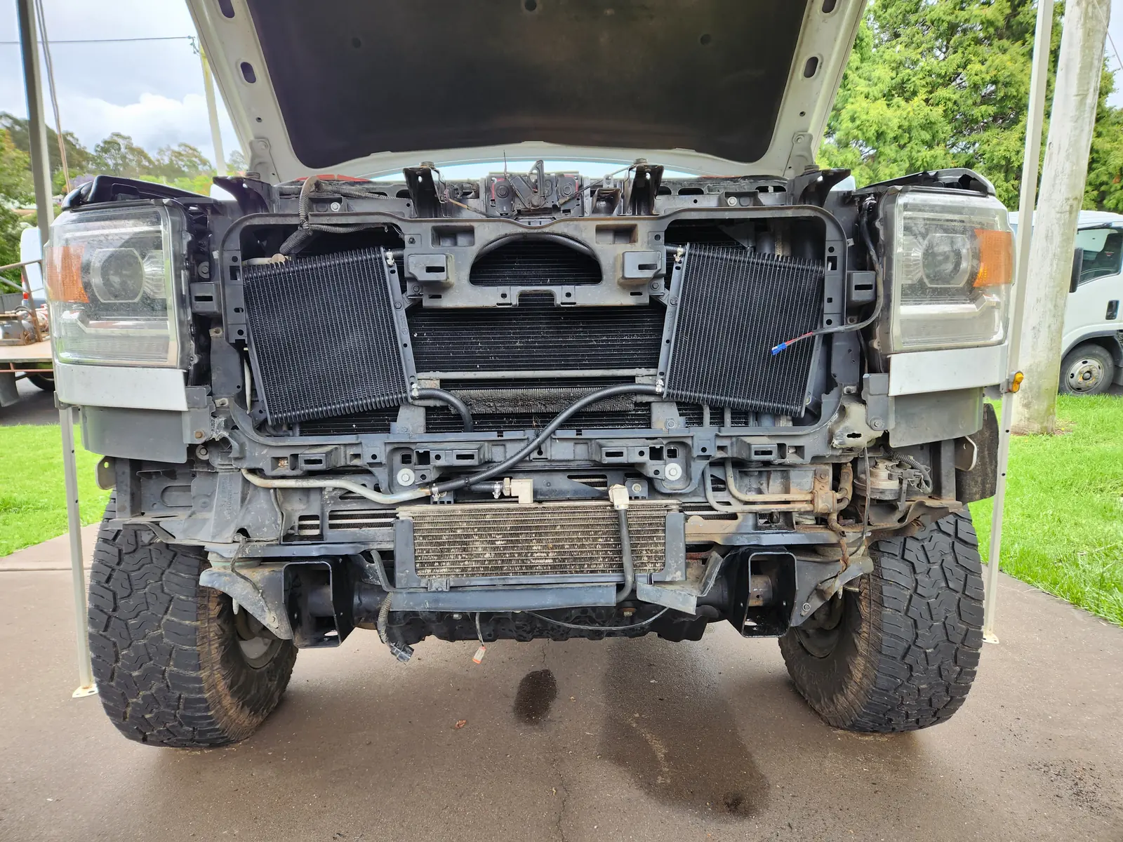 Ute with the bumper and grille removed, radiator and coolers exposed