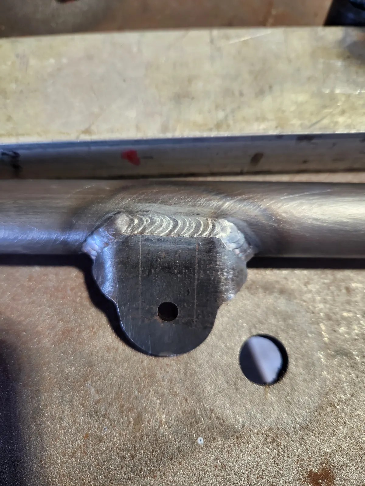 Close-up of a welded fitting on a steel tube